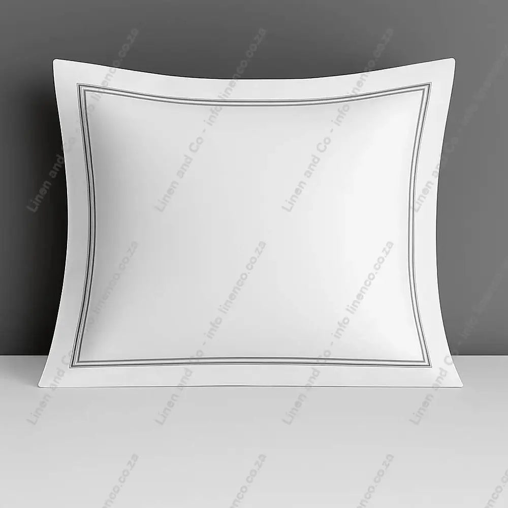 White continental pillow case with two row satin stitch on a grey background.
