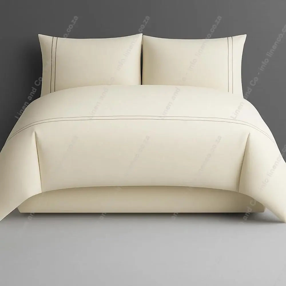 Cream two row side satin stitch duvet cover set with a grey background.