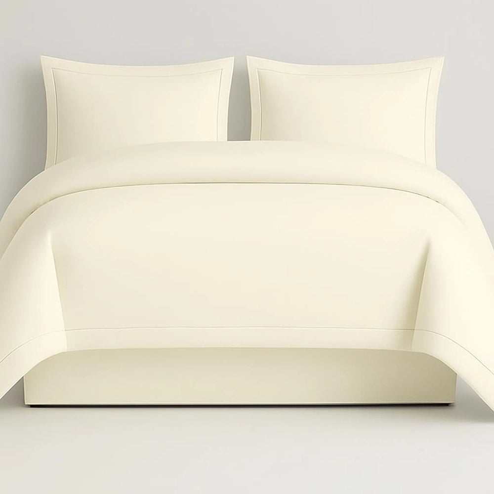 Linen and Co Cream Oxford 1 Row Satin Stitch Duvet Cover with matching Pillow Cases on a Grey background.