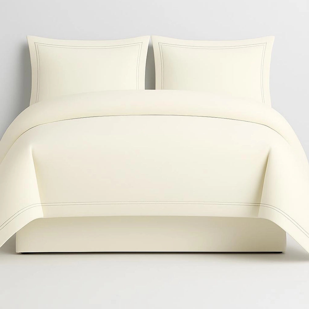 Linen and Co Cream Oxford 2 Row Satin Stitch Duvet Cover with matching Pillow Cases on a Grey background.