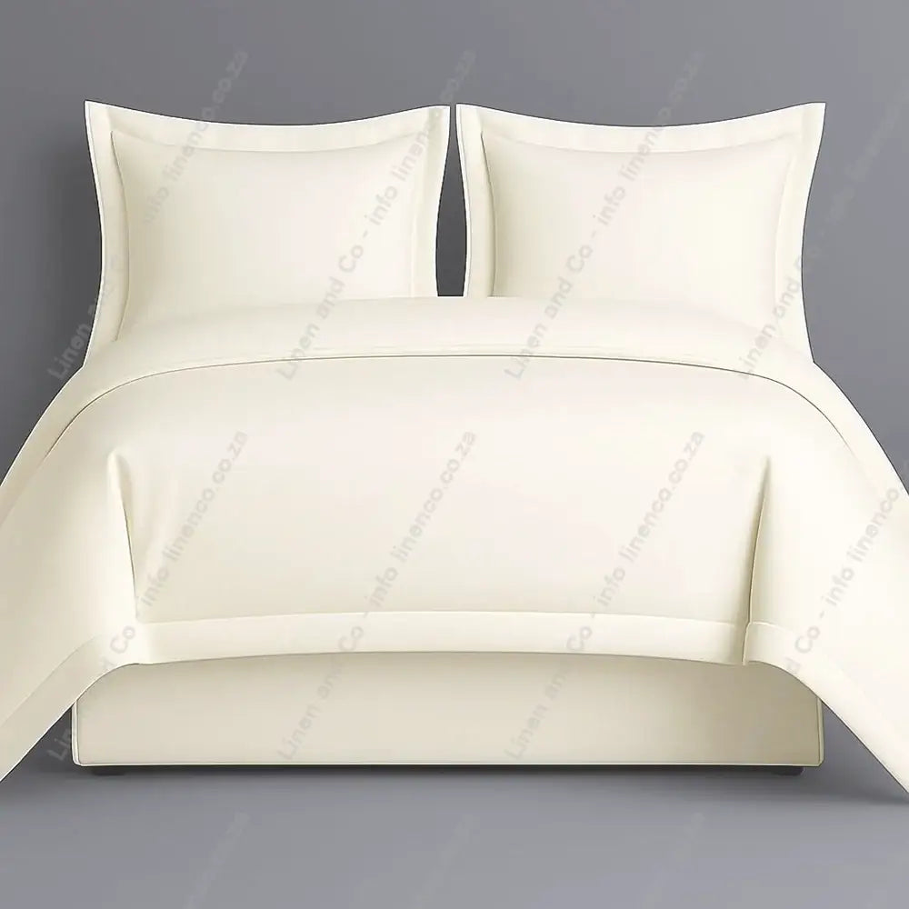 Cream oxford bedding set with two pillows on a grey background
