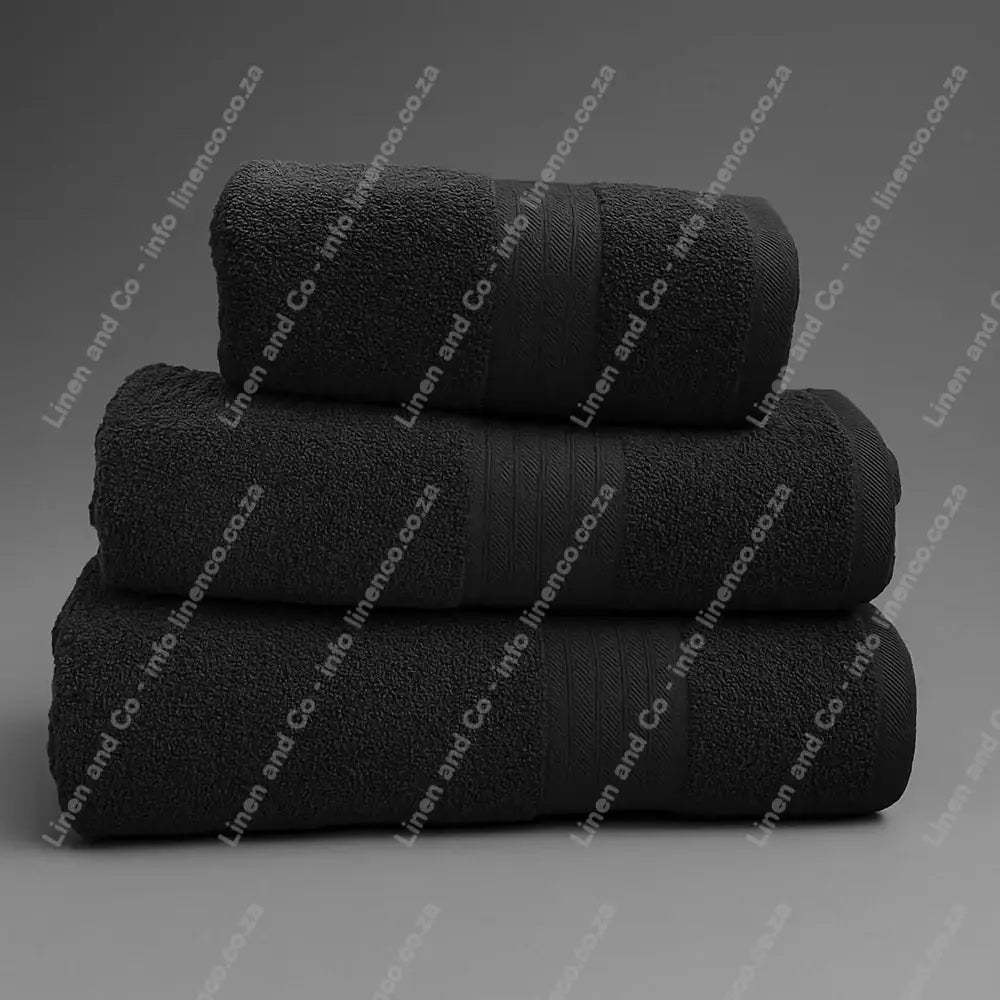 Linen and Co - Stack of three Dark Grey Egyptian 450gsm towels stacked on a grey background.