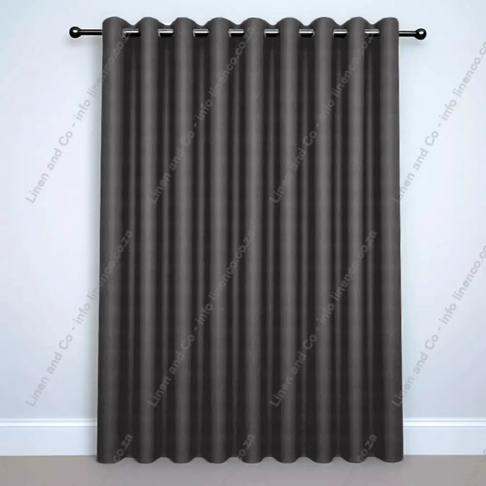 Dove Eyelet Woven Blockout curtain on a silver curtain rod