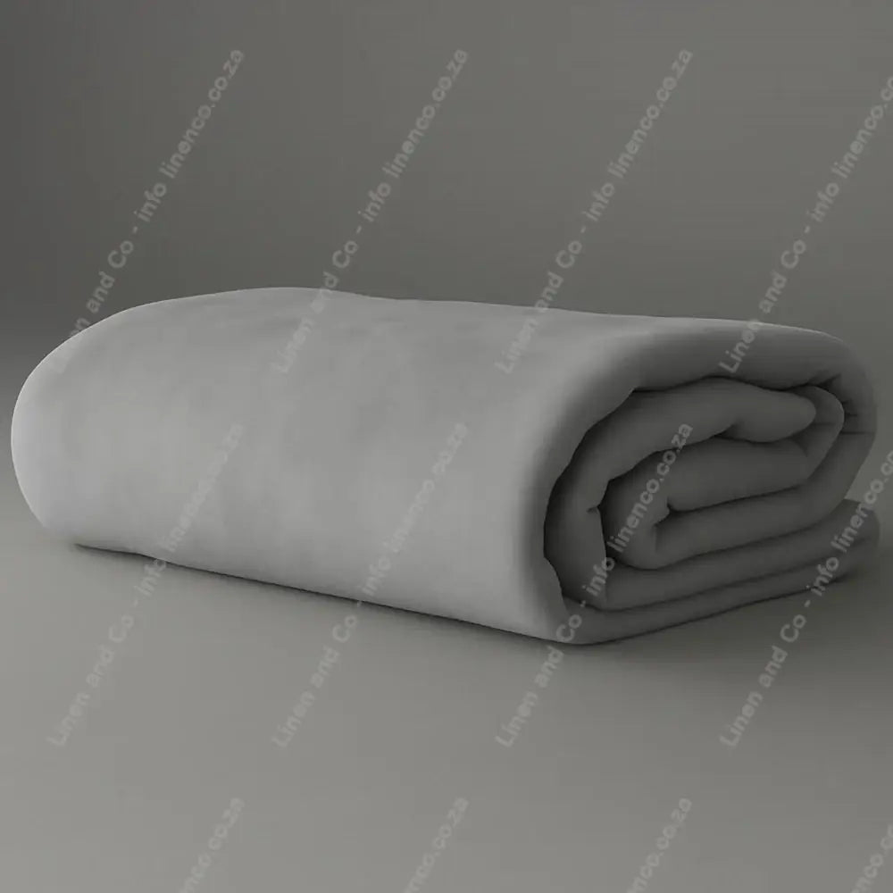 Linen and Co - Dove Grey Belfiore Hotel Blanket Folded on a Grey Background.
