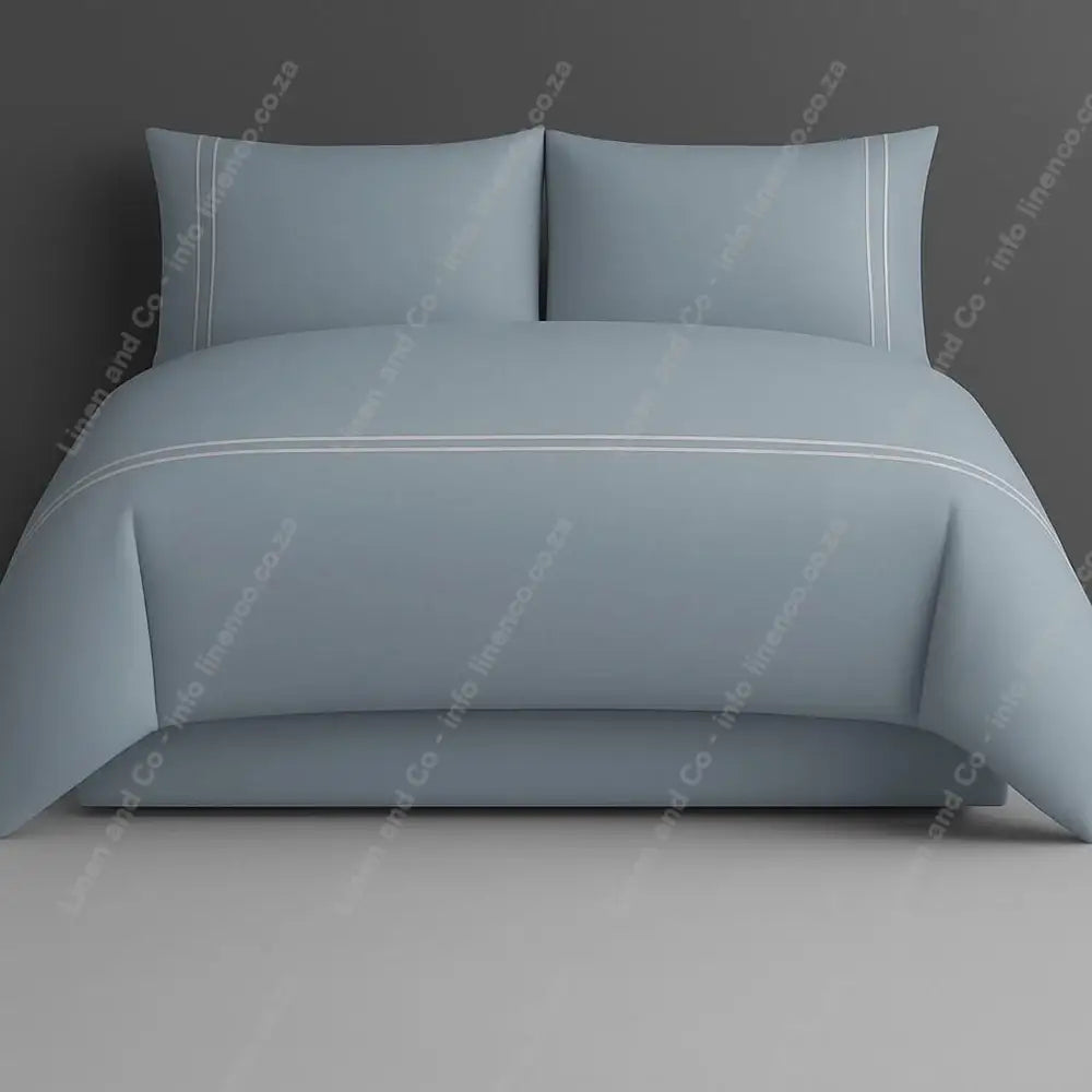 Duck egg two row side satin stitch duvet cover set with a grey background.