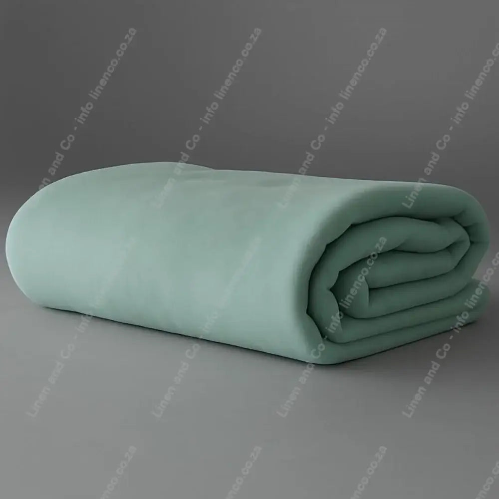 Linen and Co - Duck Egg Belfiore Hotel Blanket Folded on a Grey Background.