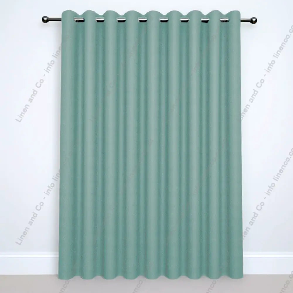 Duck Egg Eyelet Woven Blockout curtain on a silver curtain rod