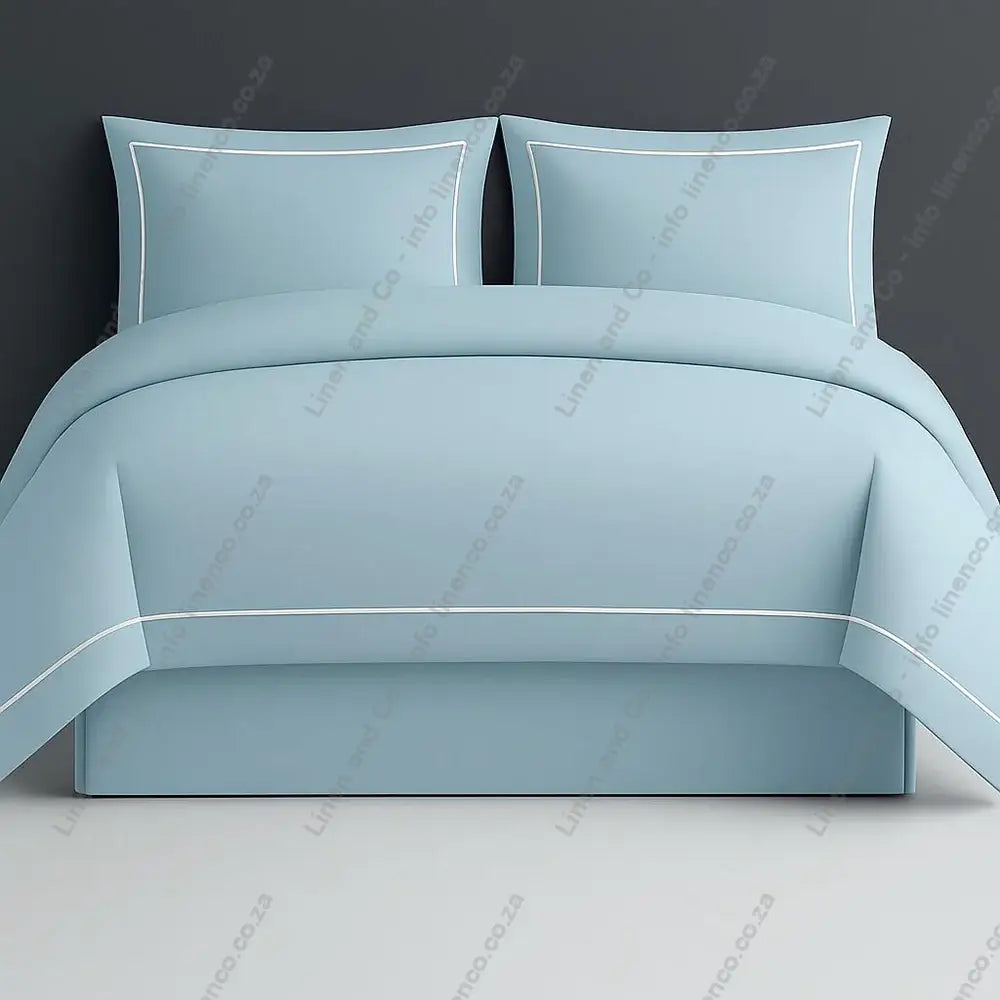 Duck Egg Oxford duvet cover with one row satin stitch with a grey a grey background