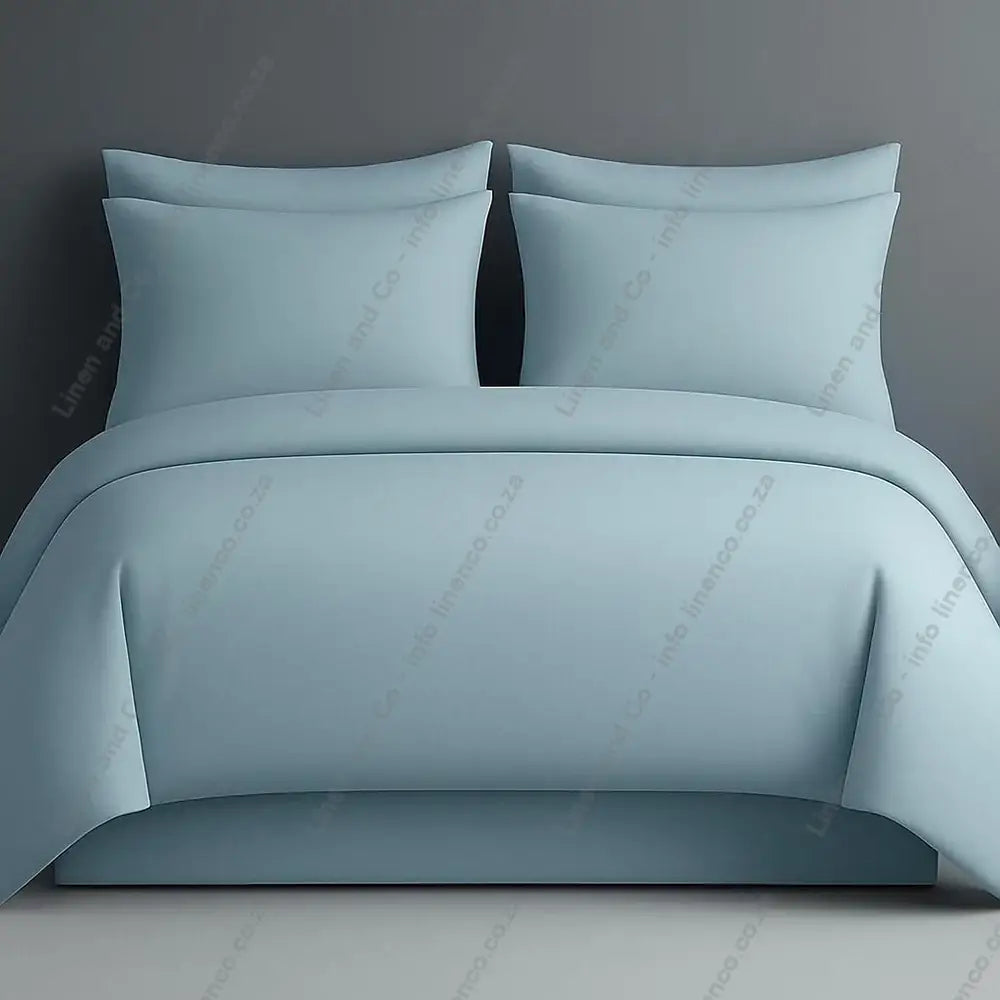 Plain style duvet cover duck egg with matching pillow cases on a grey background.