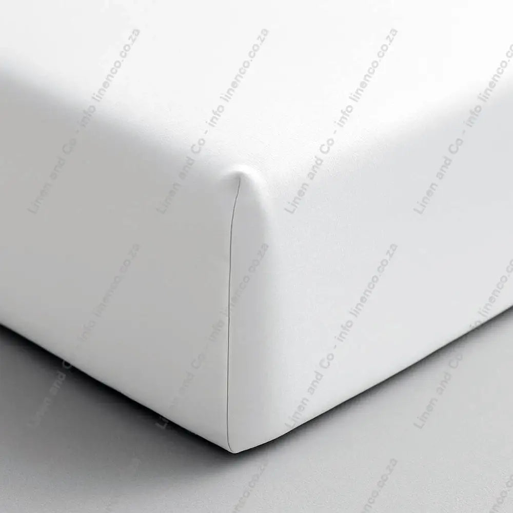 Close-up of a white fitted sheet on a bed corner