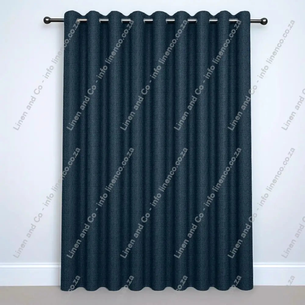 French Blue Eyelet curtain on a silver rod with silver ball finials.