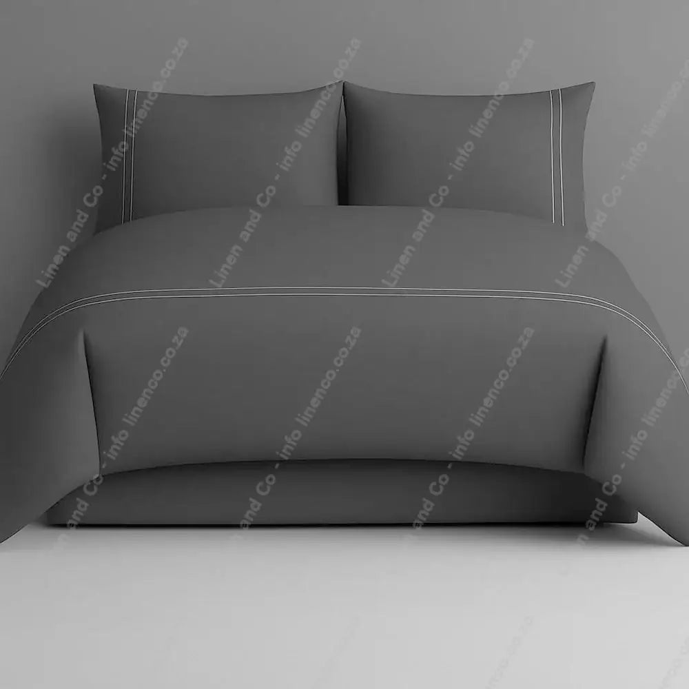 Grey two row side satin stitch duvet cover set with a grey background.