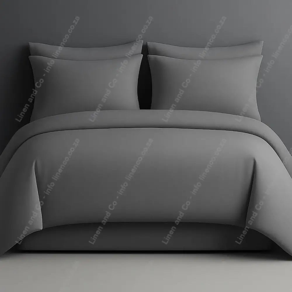 Plain style duvet cover grey with matching pillow cases on a grey background.