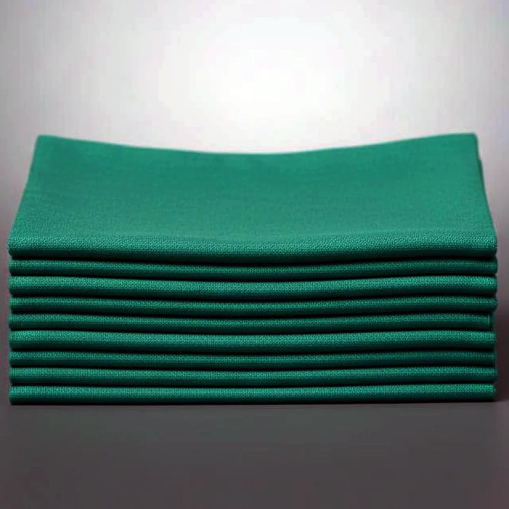 Stack of hunter green napkins on a white background