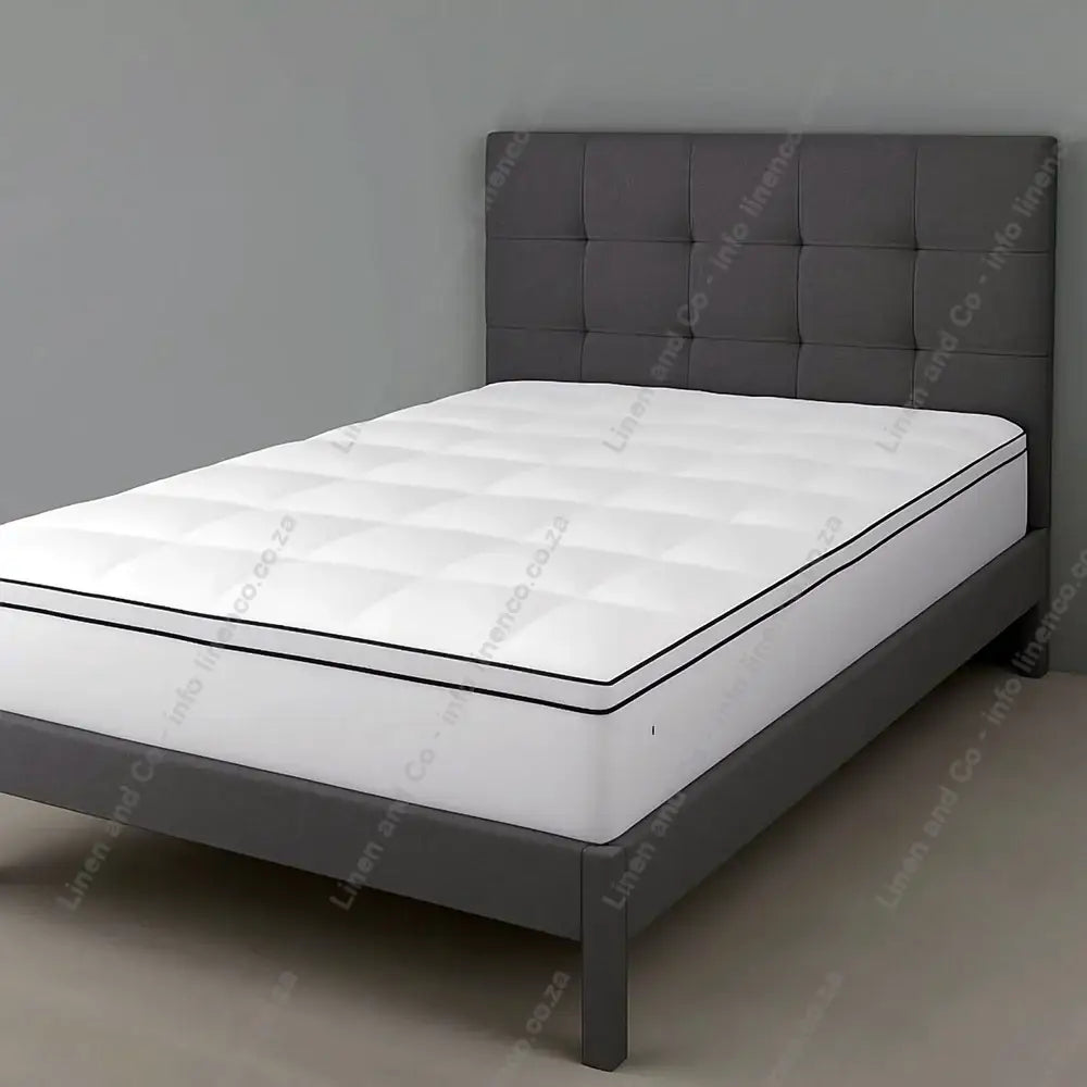 Latex Mattress Convertor or Topper on a bed with a grey background