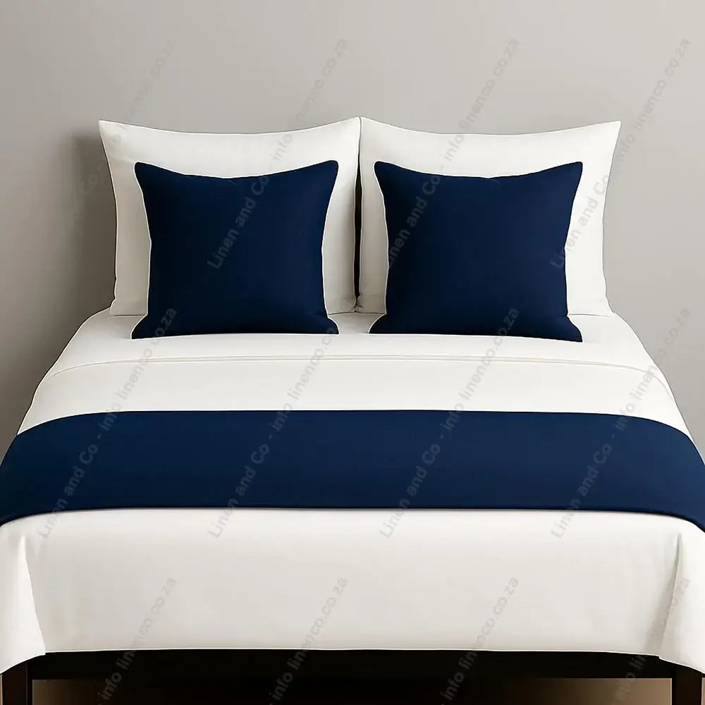 Linen and Co Navy Blue decorative bed end runner with matching scatter pillows on white linen with a grey background