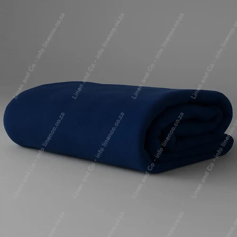 Linen and Co - Navy Belfiore Hotel Blanket Folded on a Grey Background.