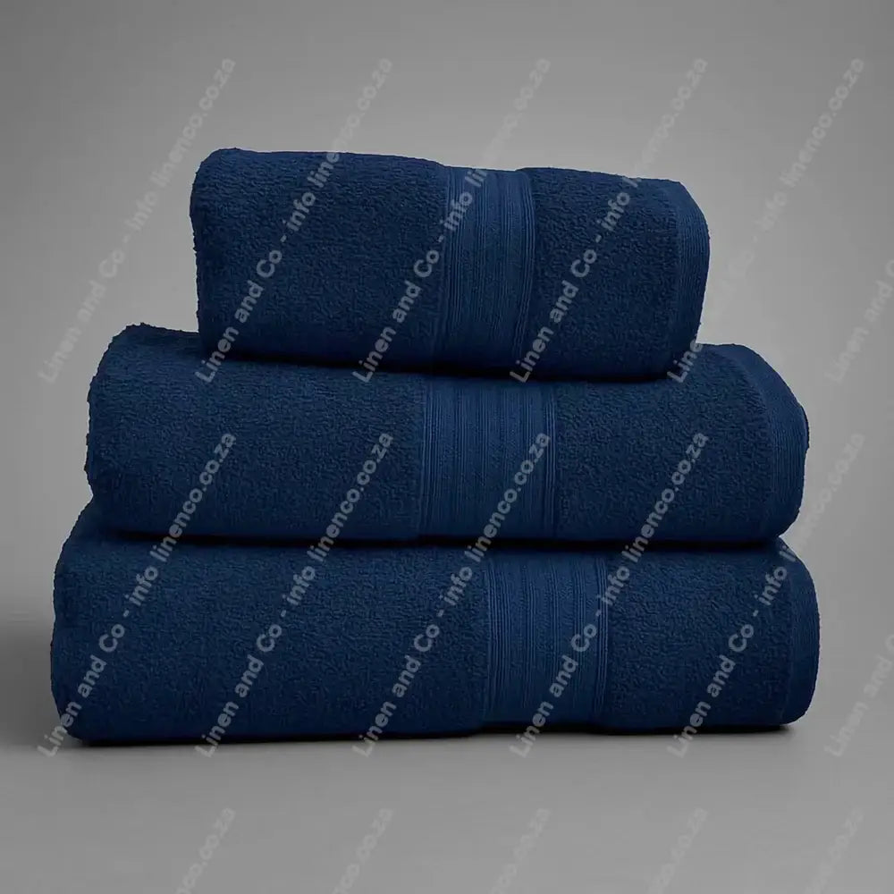 Linen and Co - Stack of three NavyBlue Egyptian 450gsm towels stacked on a grey background.