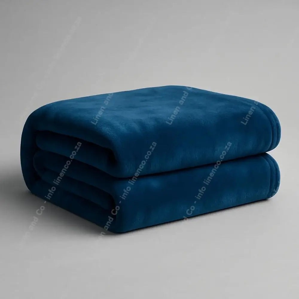 Linen and Co Navy Luxury Plush 
Blanket on a Grey Background.