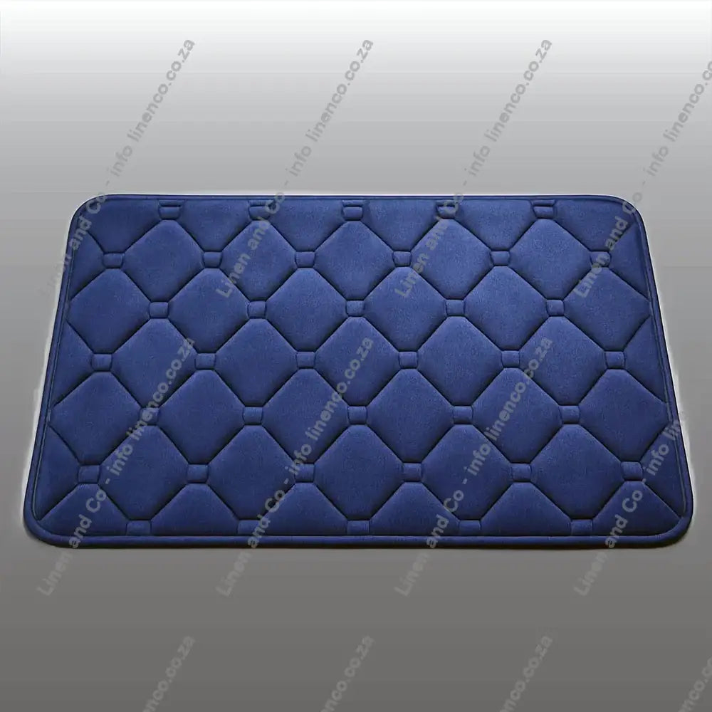 Navy Memory Foam textured bath mat on a light grey background