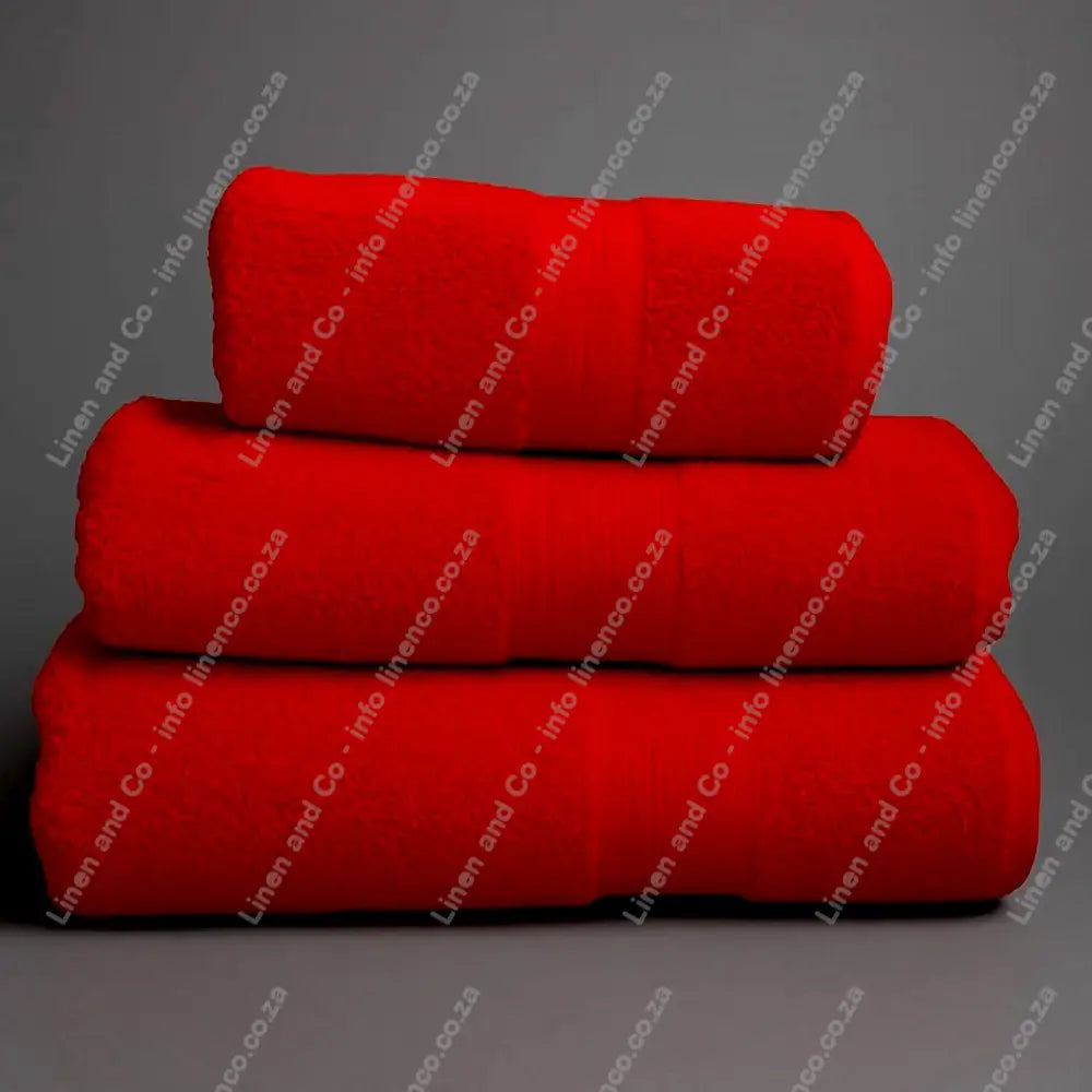 Linen and Co - Stack of three Red Egyptian 450gsm towels stacked on a grey background.