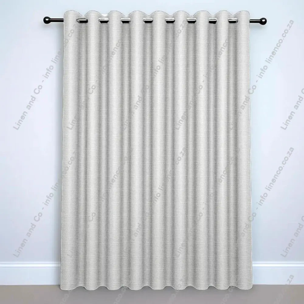 Silver Grey Eyelet curtain on a silver rod with silver ball finials.
