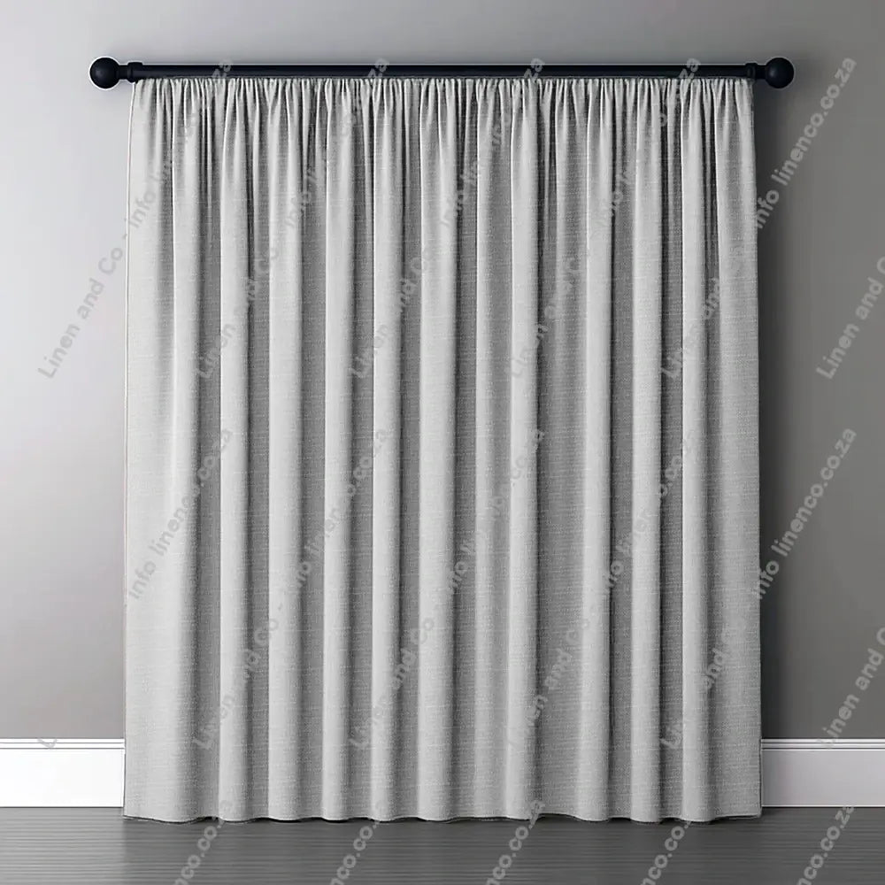 Silver Grey Curtain with normal curtain tape curtain with a dark rod.