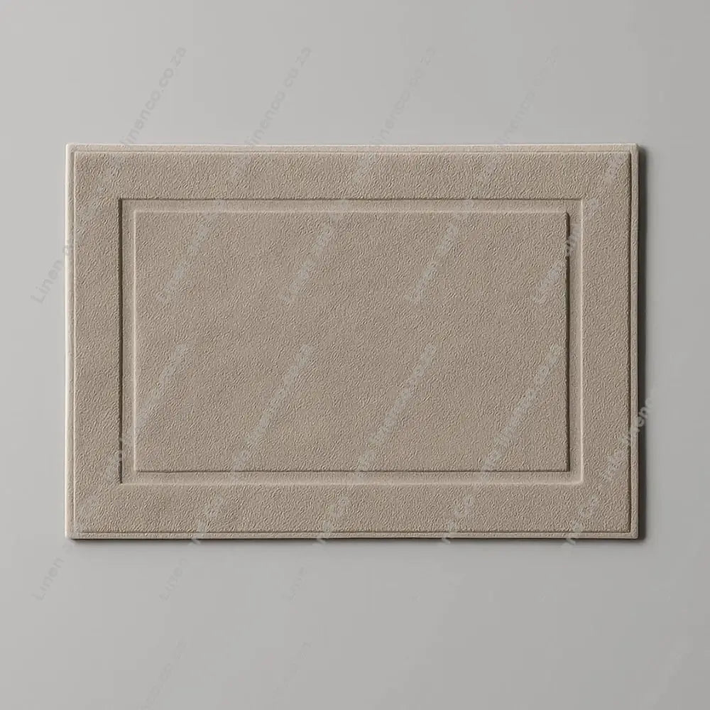 Pebble rectangular towelling bath mat on a grey background