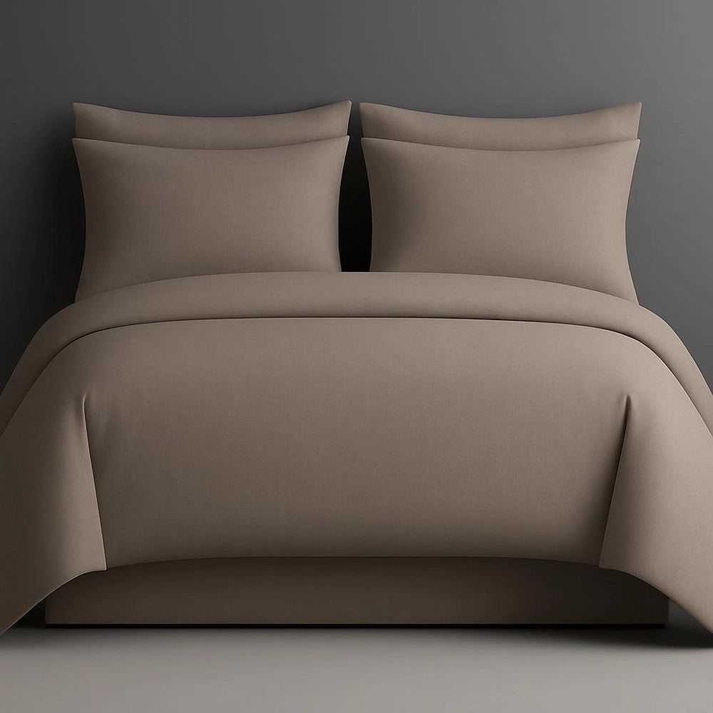 Stone bedding set with pillows on a bed against a dark gray wall.