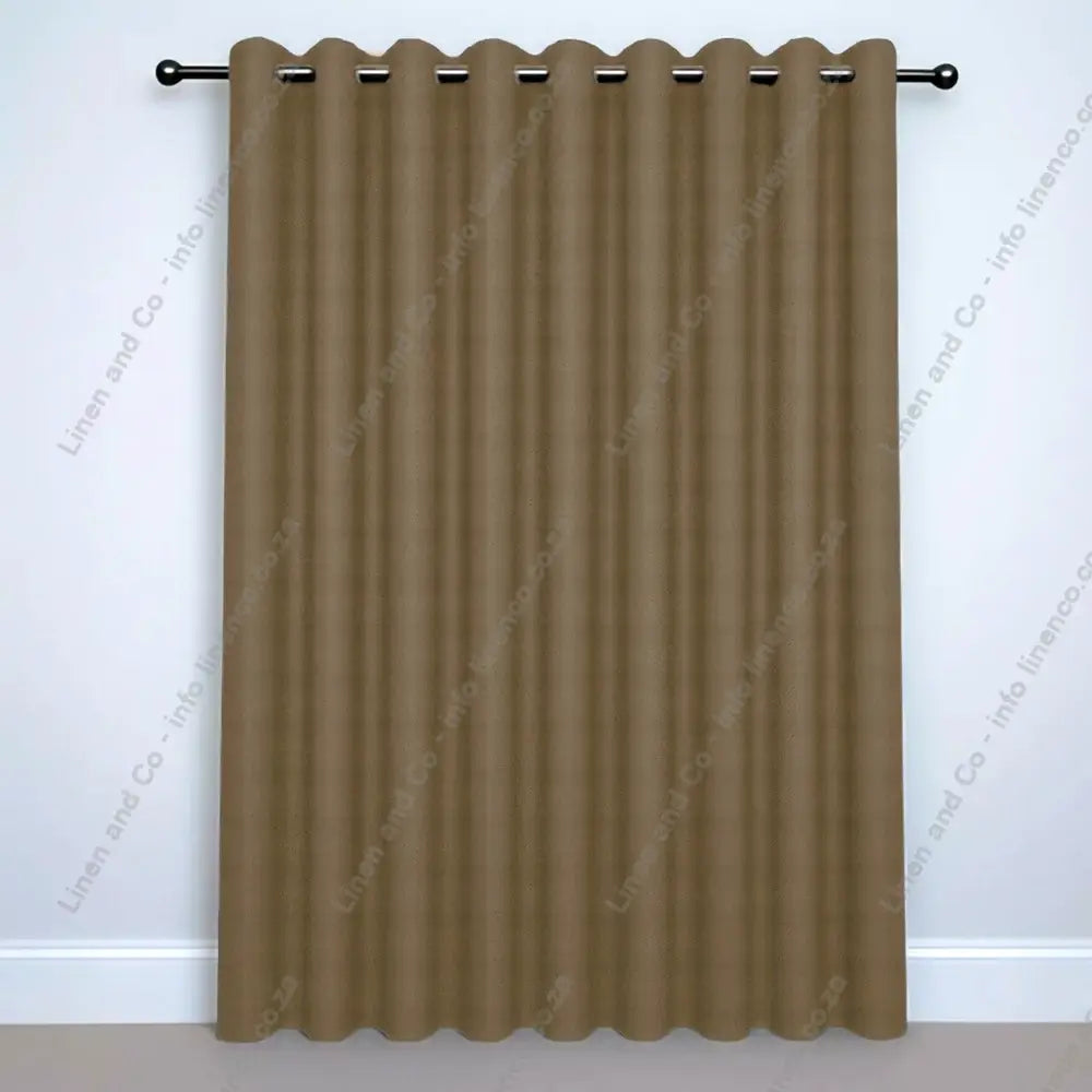 Taupe Eyelet Woven Blockout curtain on a silver curtain rod