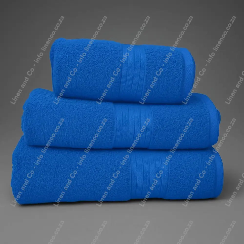 Linen and Co - Stack of three Teal Egyptian 450gsm towels stacked on a grey background.
