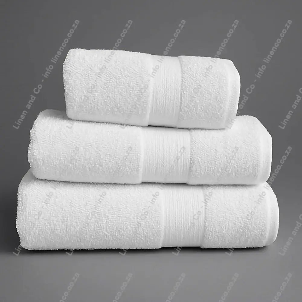 Linen and Co - Stack of three White Egyptian 450gsm towels stacked on a grey background.