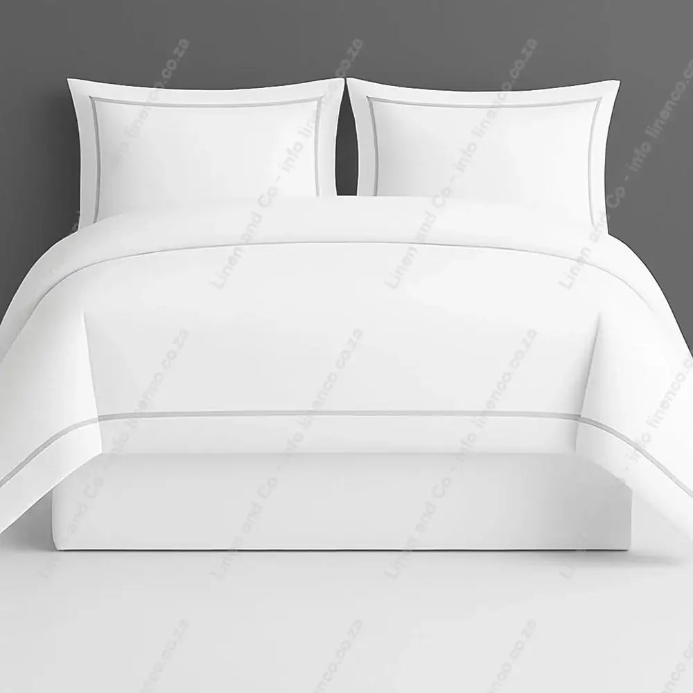 Oxford Duvet Cover white with grey two row satin stitch with matching pillow cases on a grey background
