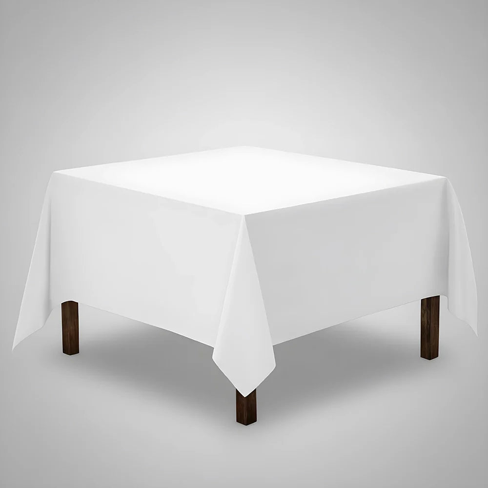 White table Cloth on a square table with a light background