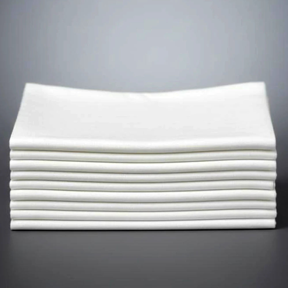 Stack of white folded napkins on a grey background