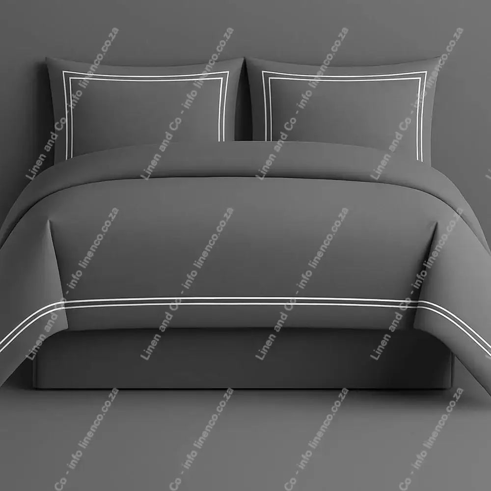 Oxford Duvet Cover Grey with white two row satin stitch with matching pillow cases on a grey background