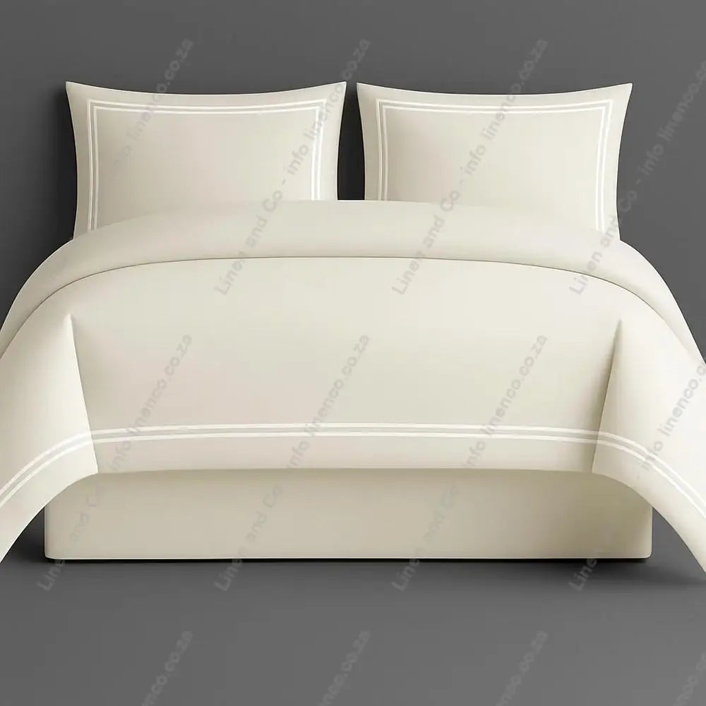 Oxford Duvet Cover Cream with white two row satin stitch with matching pillow cases on a grey background