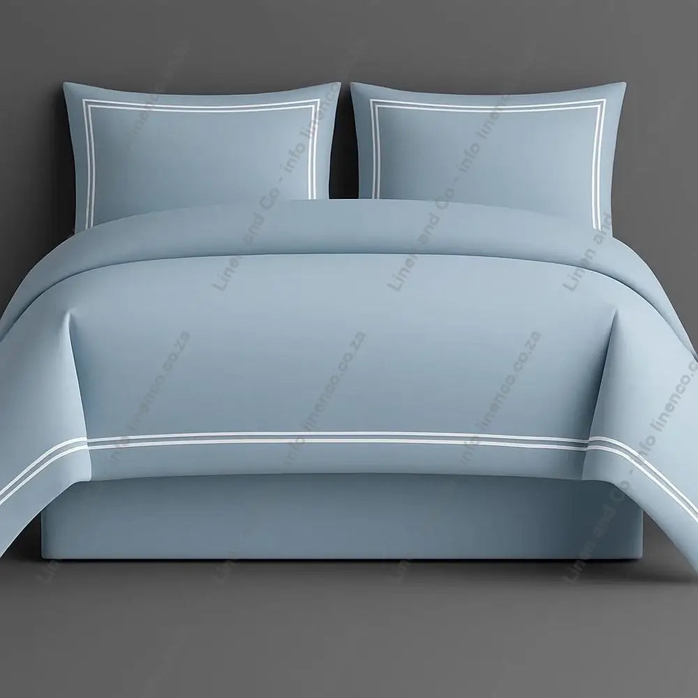 Oxford Duvet Cover Duck Egg with white two row satin stitch with matching pillow cases on a grey background