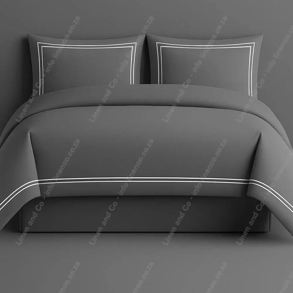Oxford Duvet Cover Grey with white two row satin stitch with matching pillow cases on a grey background