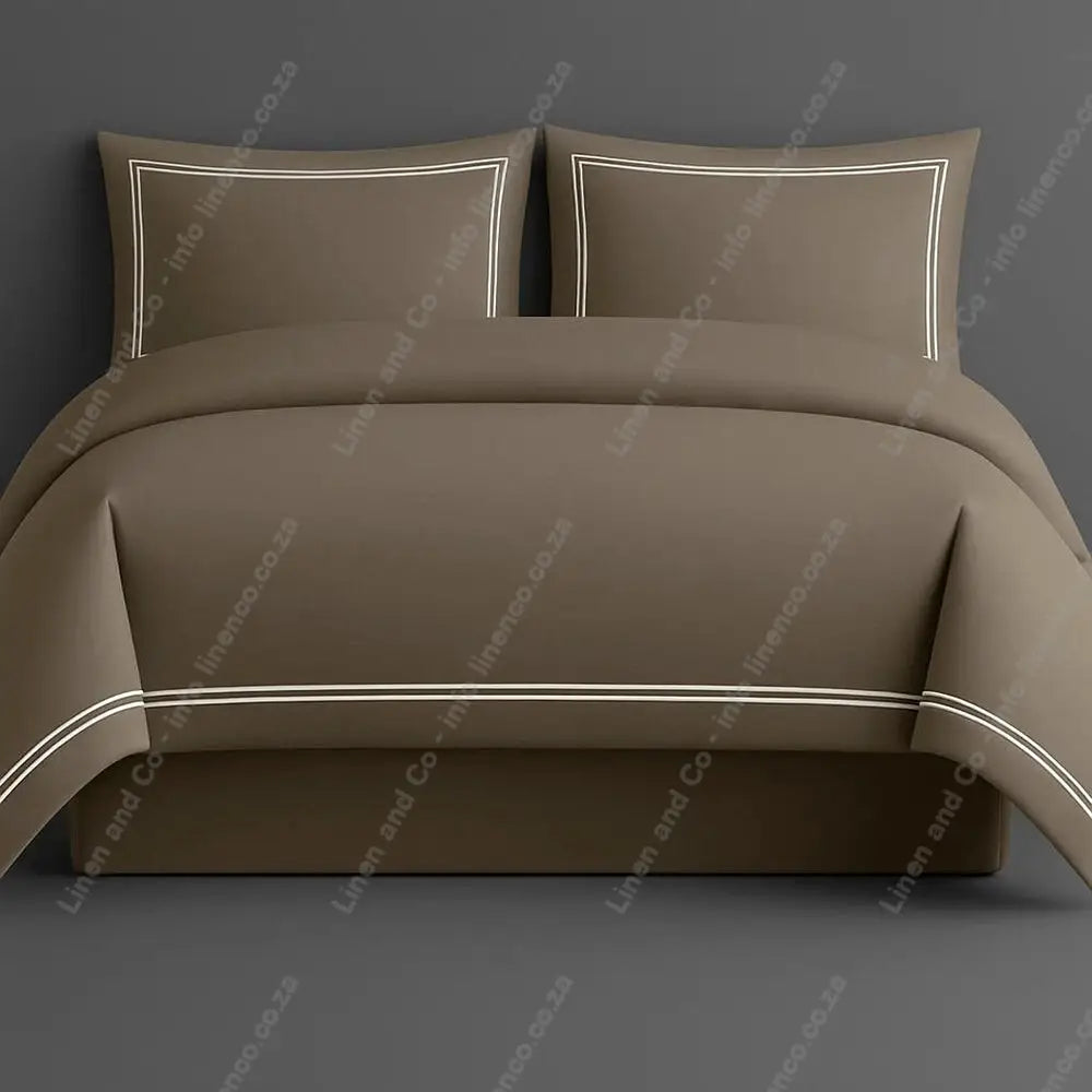 Oxford Duvet Cover Stone with white two row satin stitch with matching pillow cases on a grey background