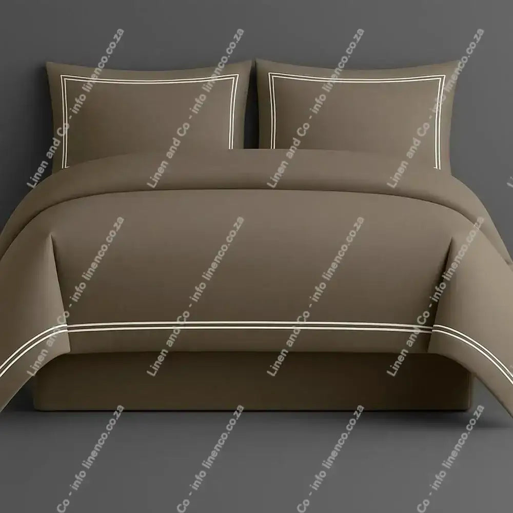 Oxford Duvet Cover Stone with white two row satin stitch with matching pillow cases on a grey background