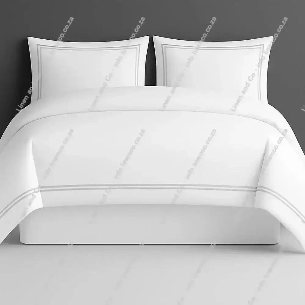 Oxford Duvet Cover white with grey two row satin stitch with matching pillow cases on a grey background
