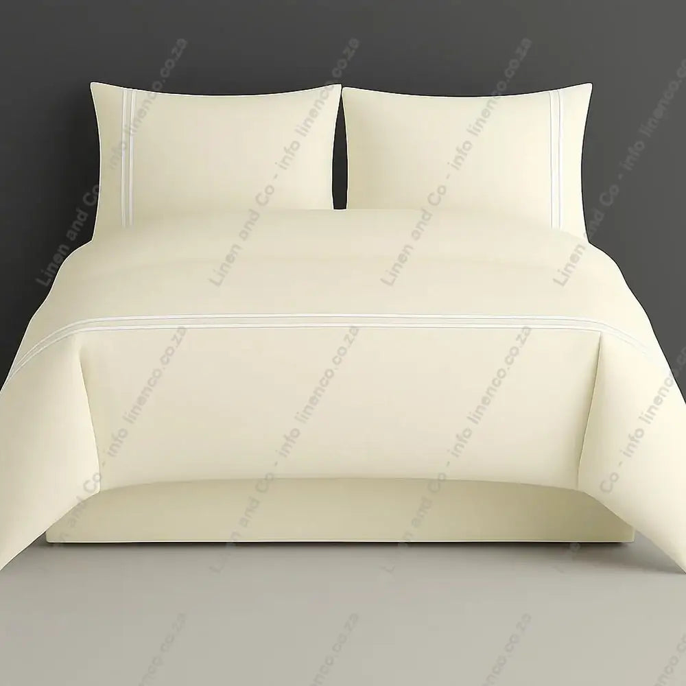 Cream plain duvet cover set with white two row satin stitch on a grey background