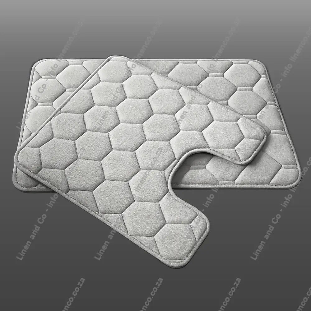 Platinum Light Grey Memory Foam bath mat set textured bath mat on a light grey background