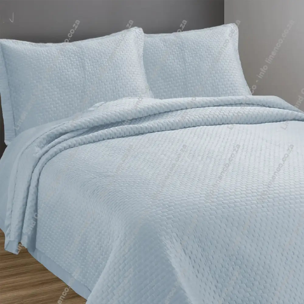 Marine Berlin design quilted bedspread with matching pillow cases on a bed.