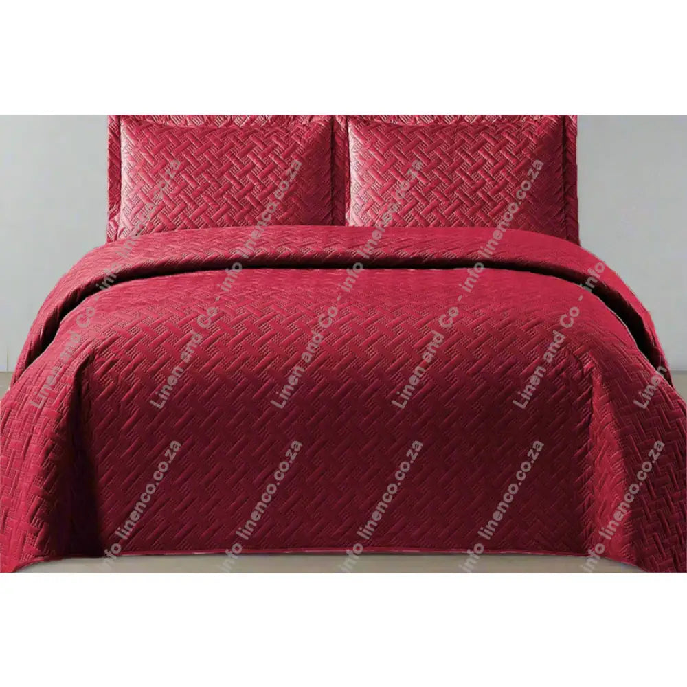 Maroon Italian Velvet quilted bedspread set on a bed with matching pillows