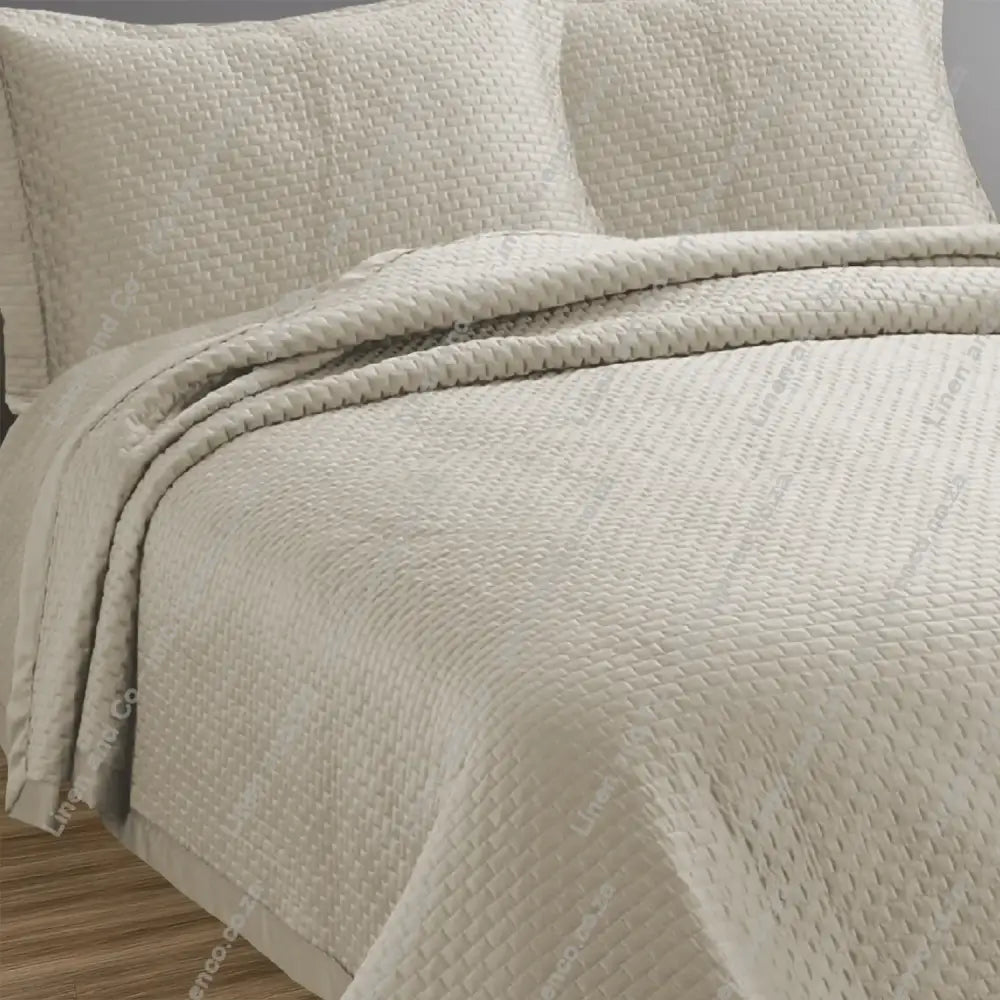 Natural Berlin design quilted bedspread with matching pillow cases on a bed.