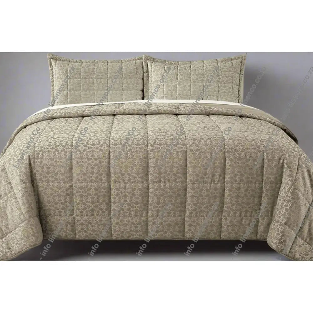 Natural Cologne Design quilted comforter set on a bed with matching pillows.