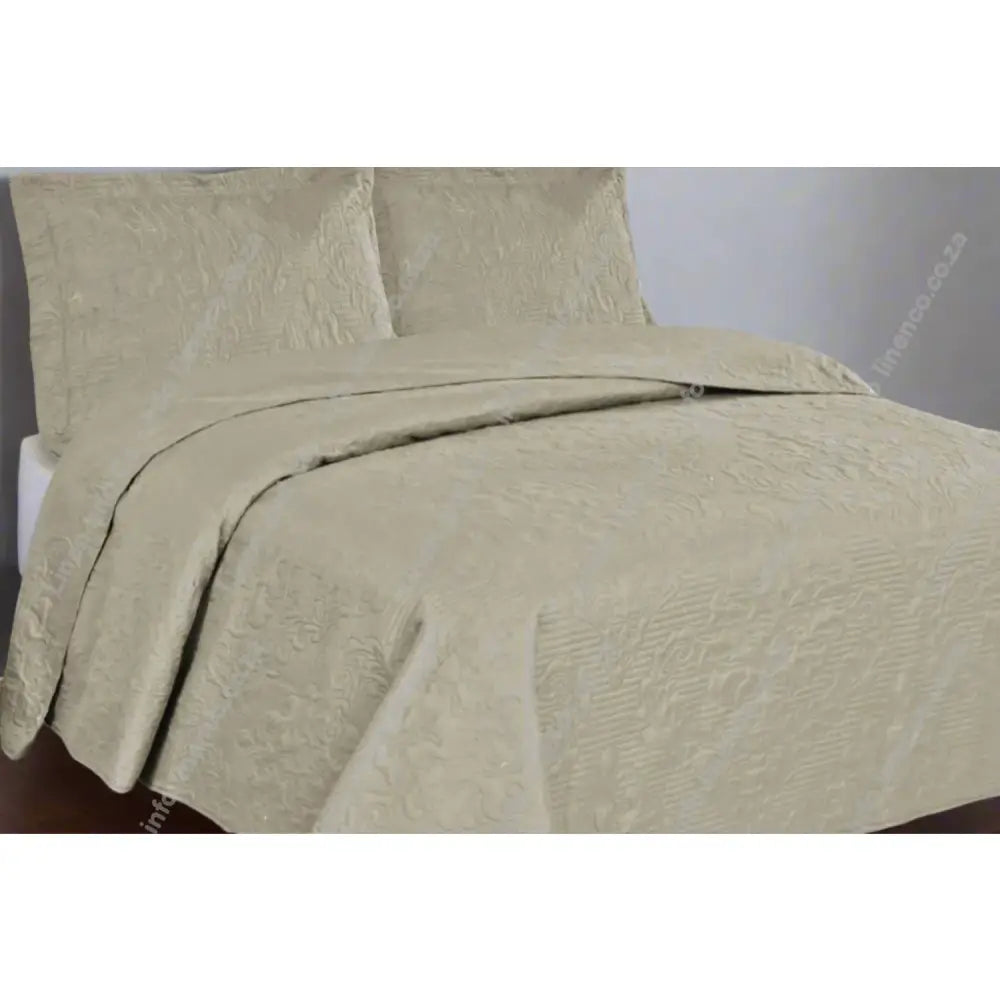 Natural Melissa Design textured quilt and pillow set on a bed in a bedroom setting.