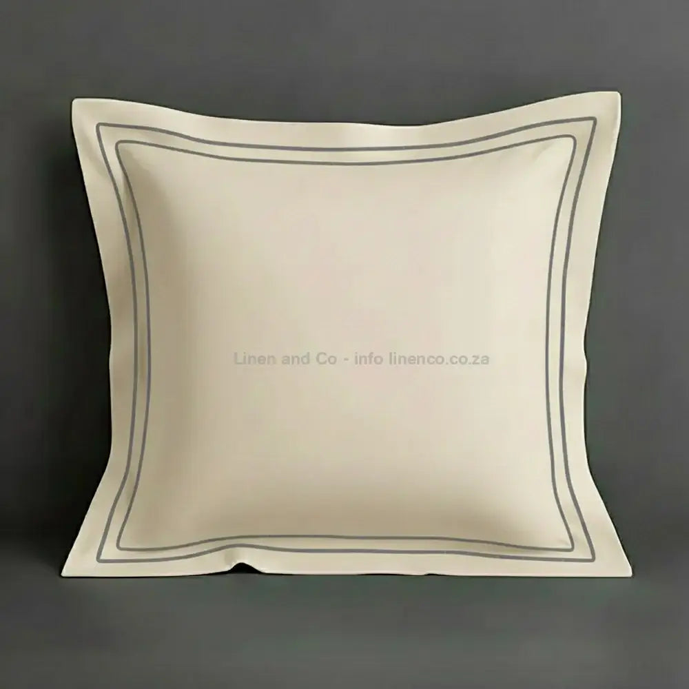 Cream continental oxford pillow case with grey two row satin stitch detail on a grey background. Luxury Hotel Linen by Linen and Co.